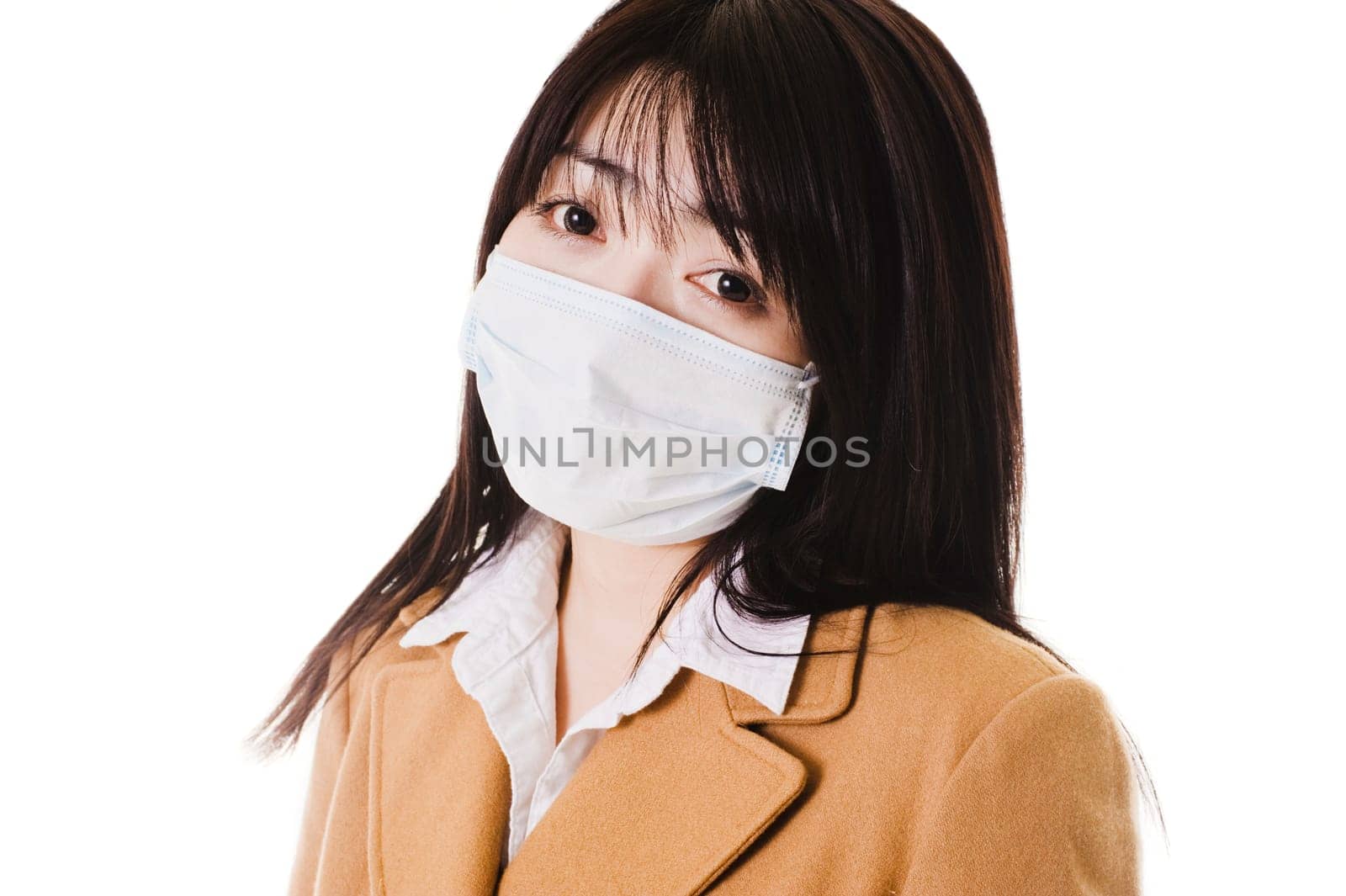 Closeup of a sick Chinese school girl wearing a face mask.