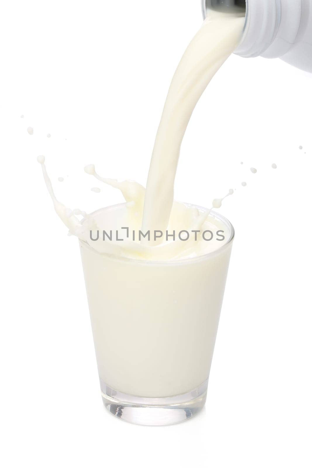 Bottle pouring milk into a glass. Splash