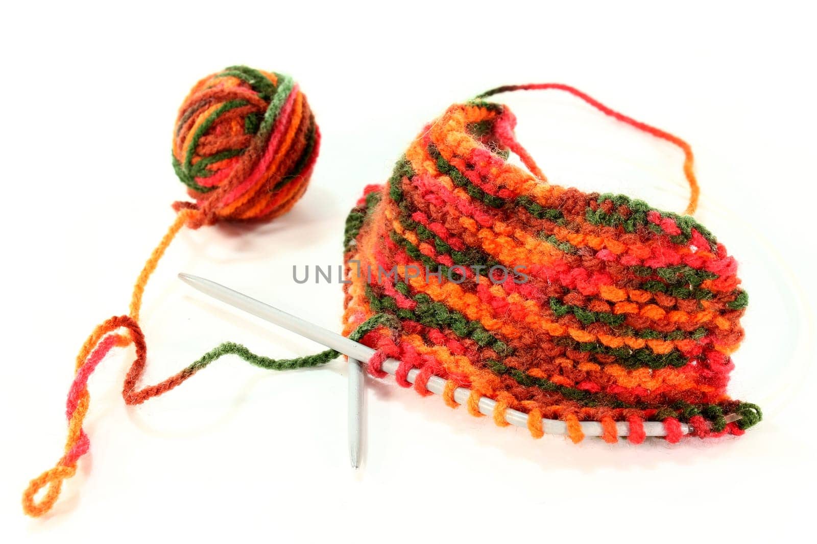 a colourful ball of wool with a knitting sample