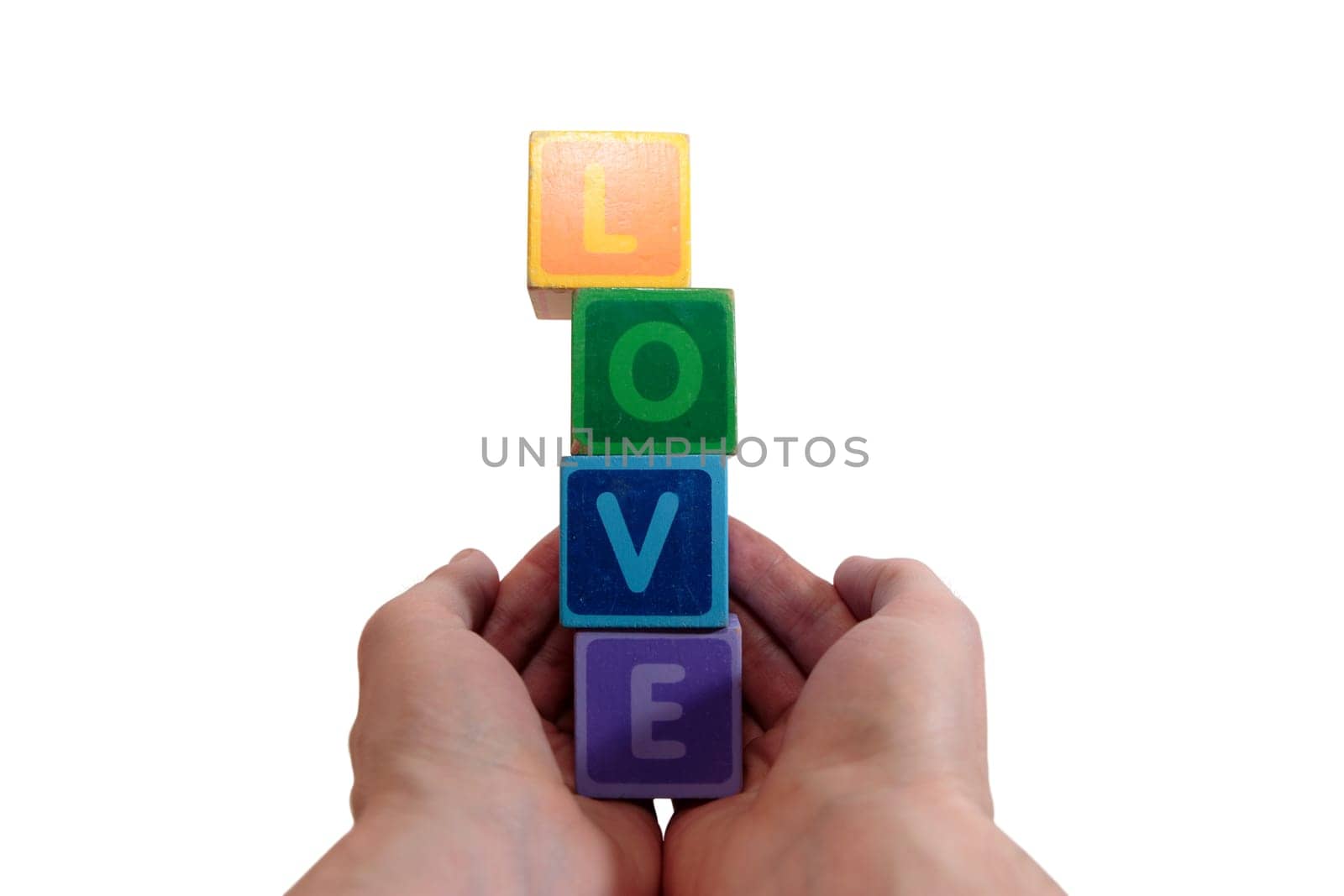 childrens toy letters in outstretched hands  against a white background that spell love with clipping path