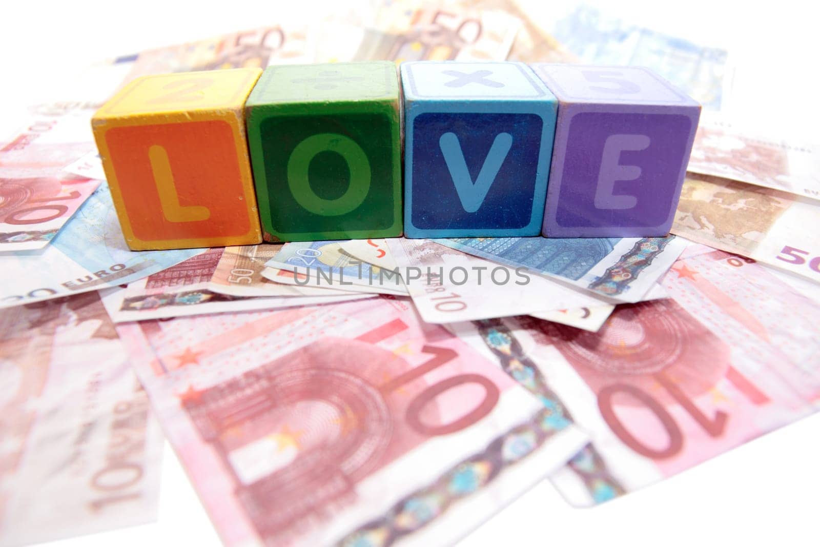 assorted childrens toy letter building blocks on money that spell love