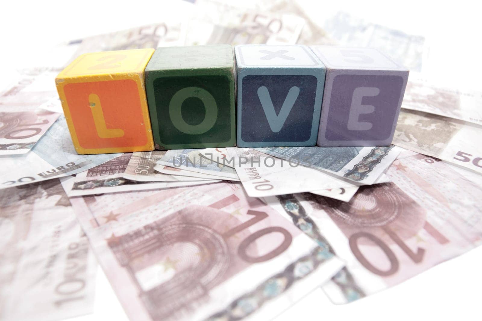 assorted childrens toy letter building blocks on money that spell love