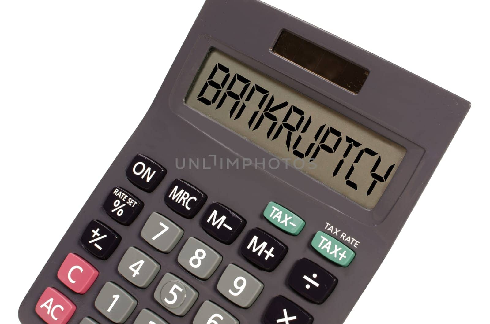 bankruptcy written on display of an old calculator on white background in perspective