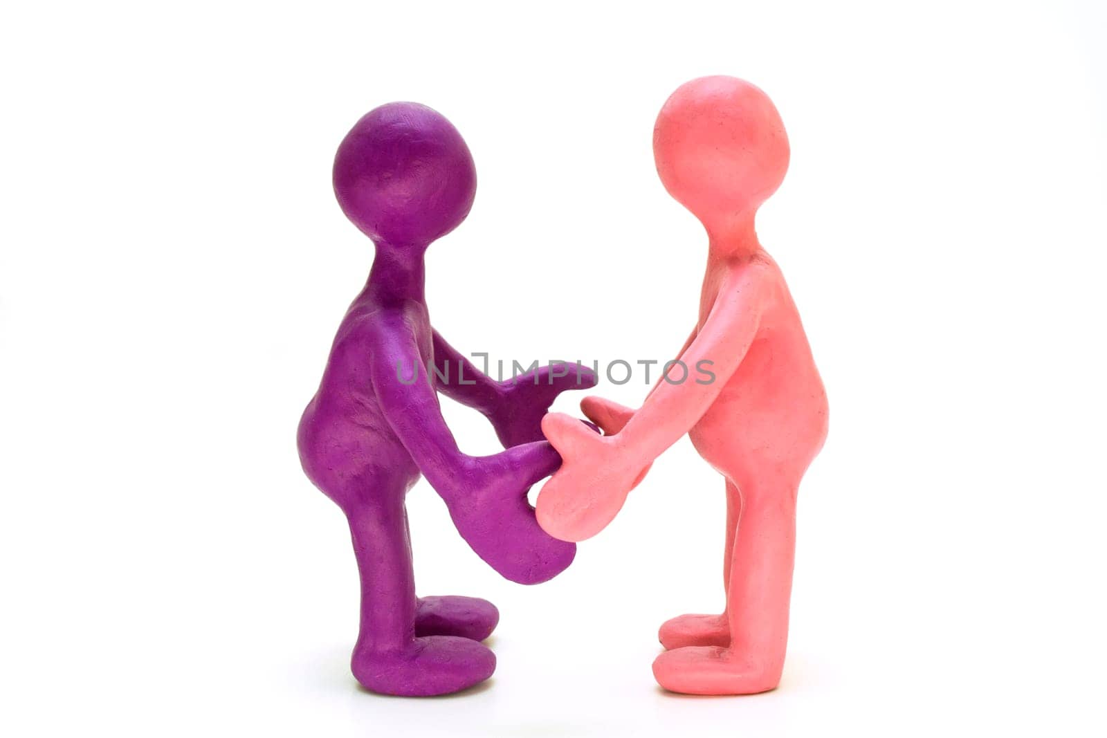 Two colored plasticine puppets standing opposite each other