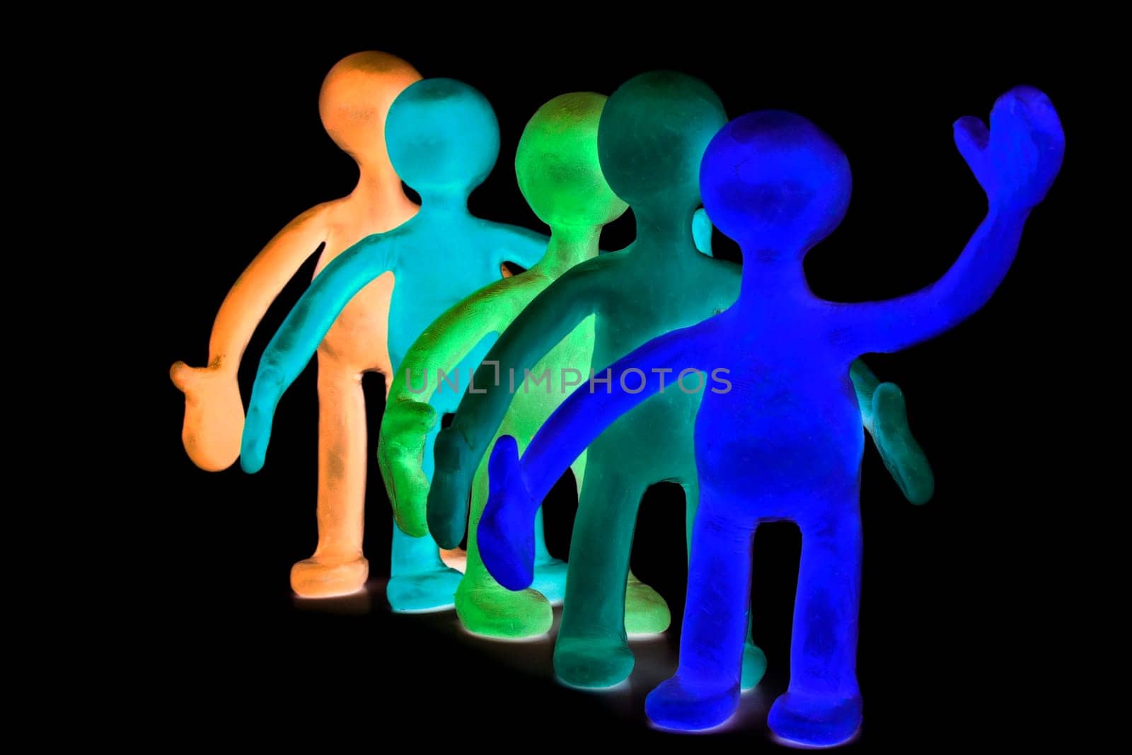 Shaded group of plasticine puppets signing by hands