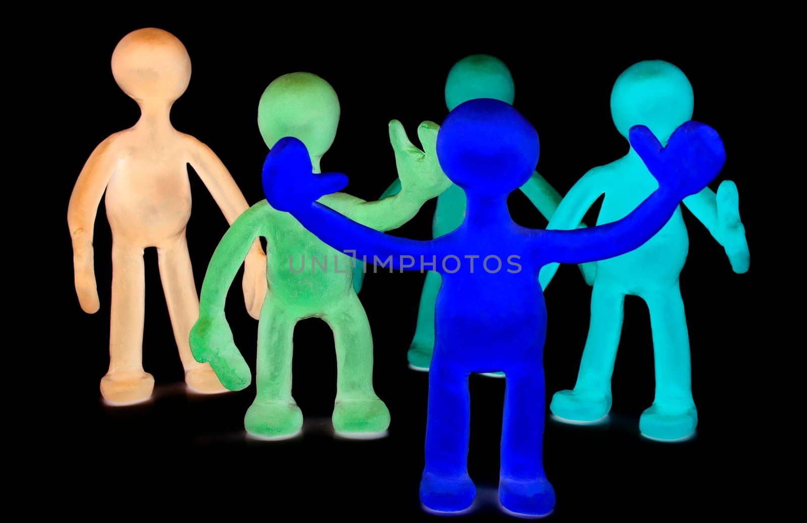Shaded group of plasticine puppets on black background