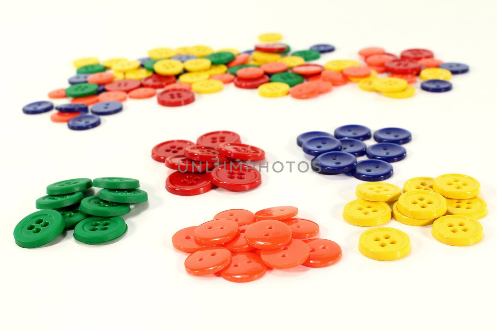 many colorful buttons in front of a white background