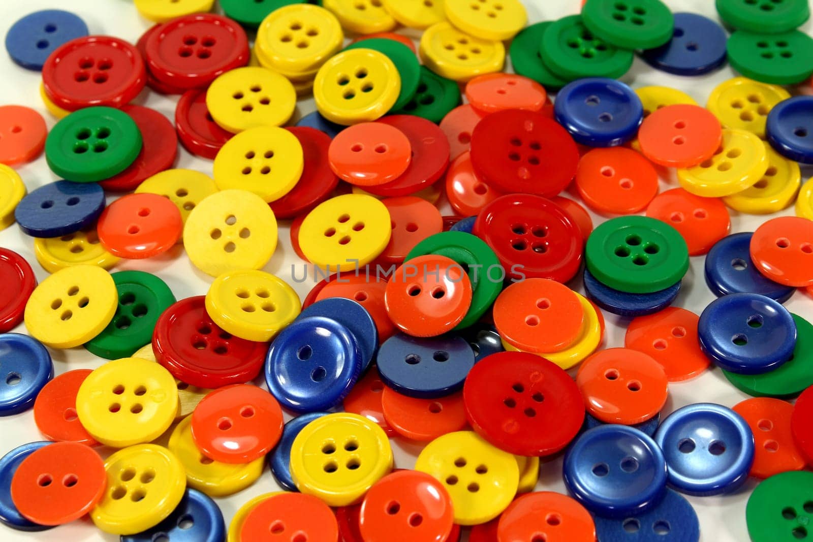 many colorful buttons in front of a white background