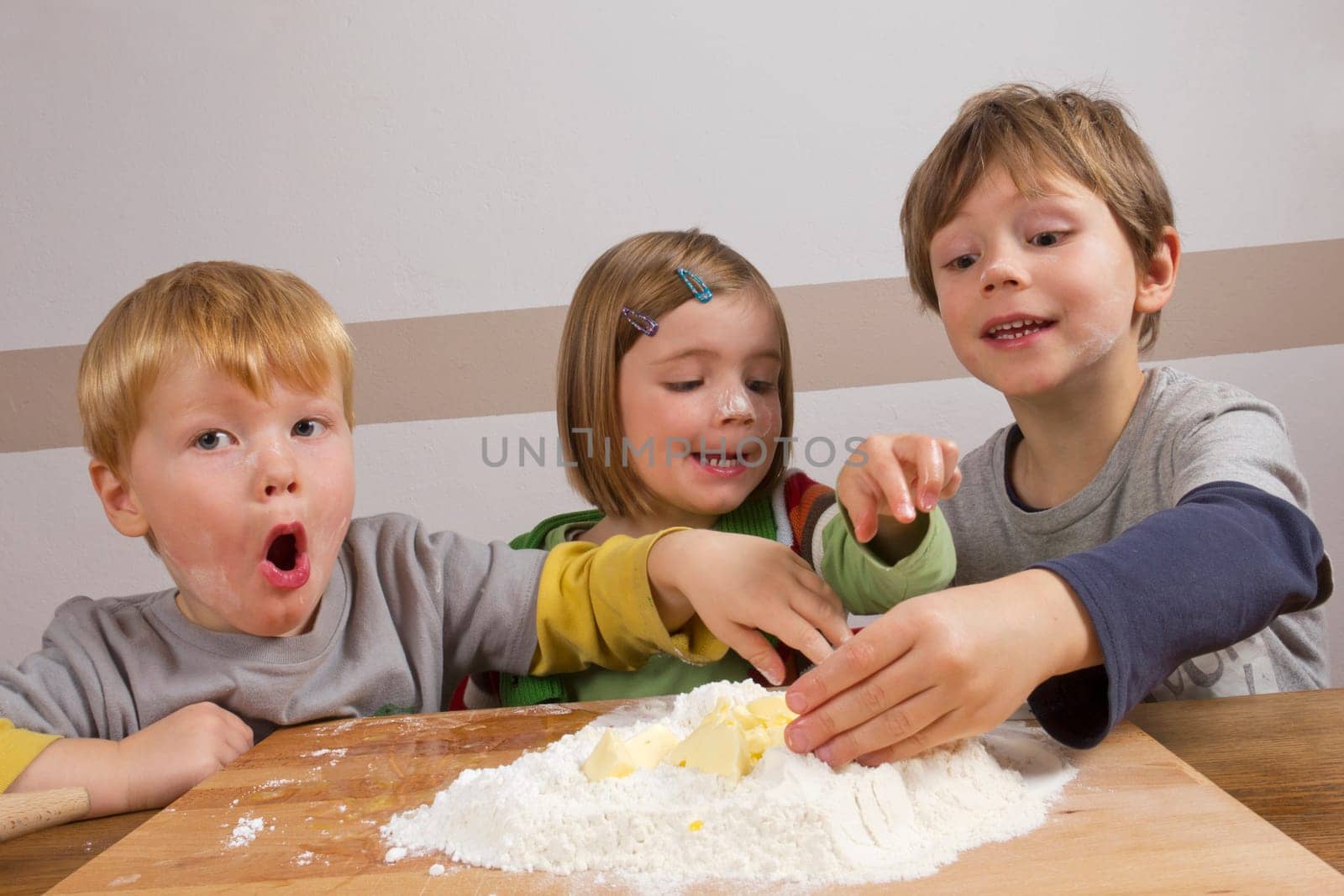 Children have fun kneading dough