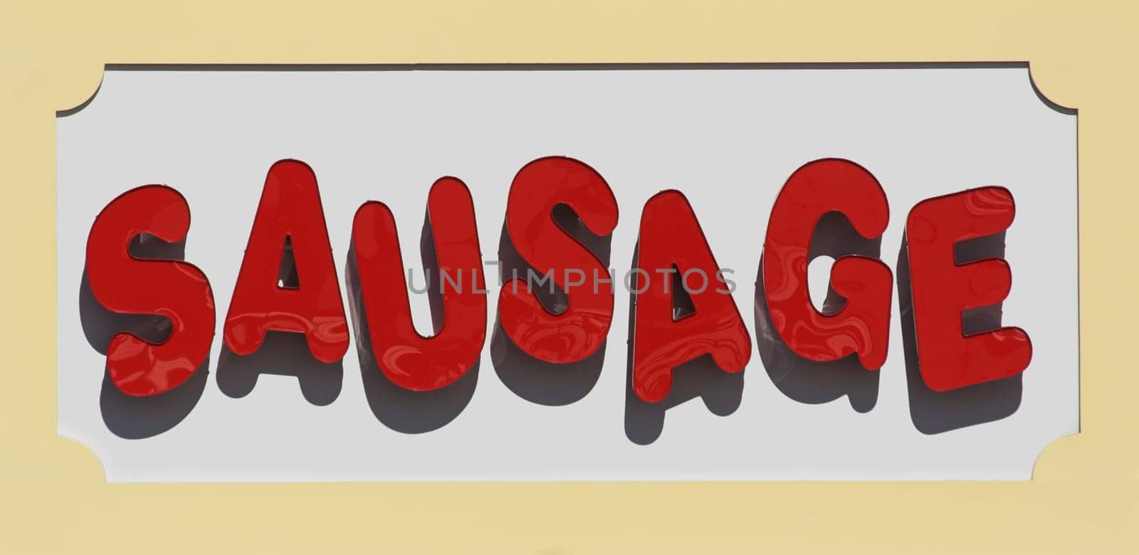 Large sausage sign near restaurant on a boardwalk