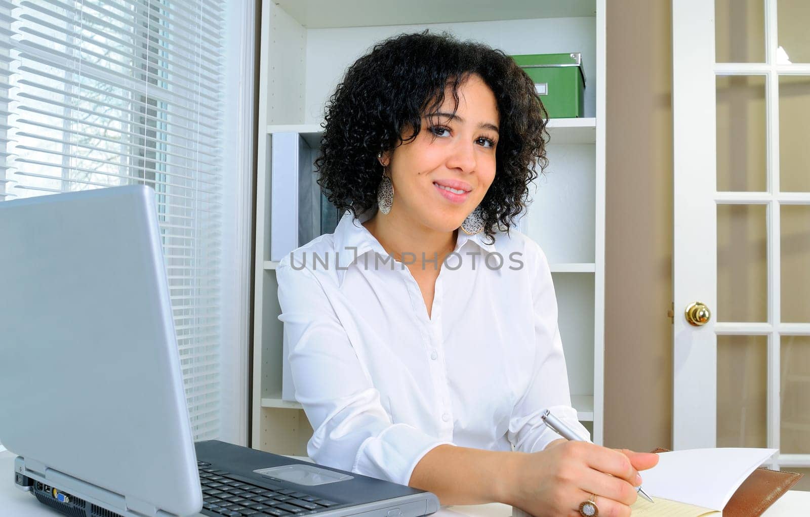 African American Business Woman Sat At Her Desk With A Laptop Computer