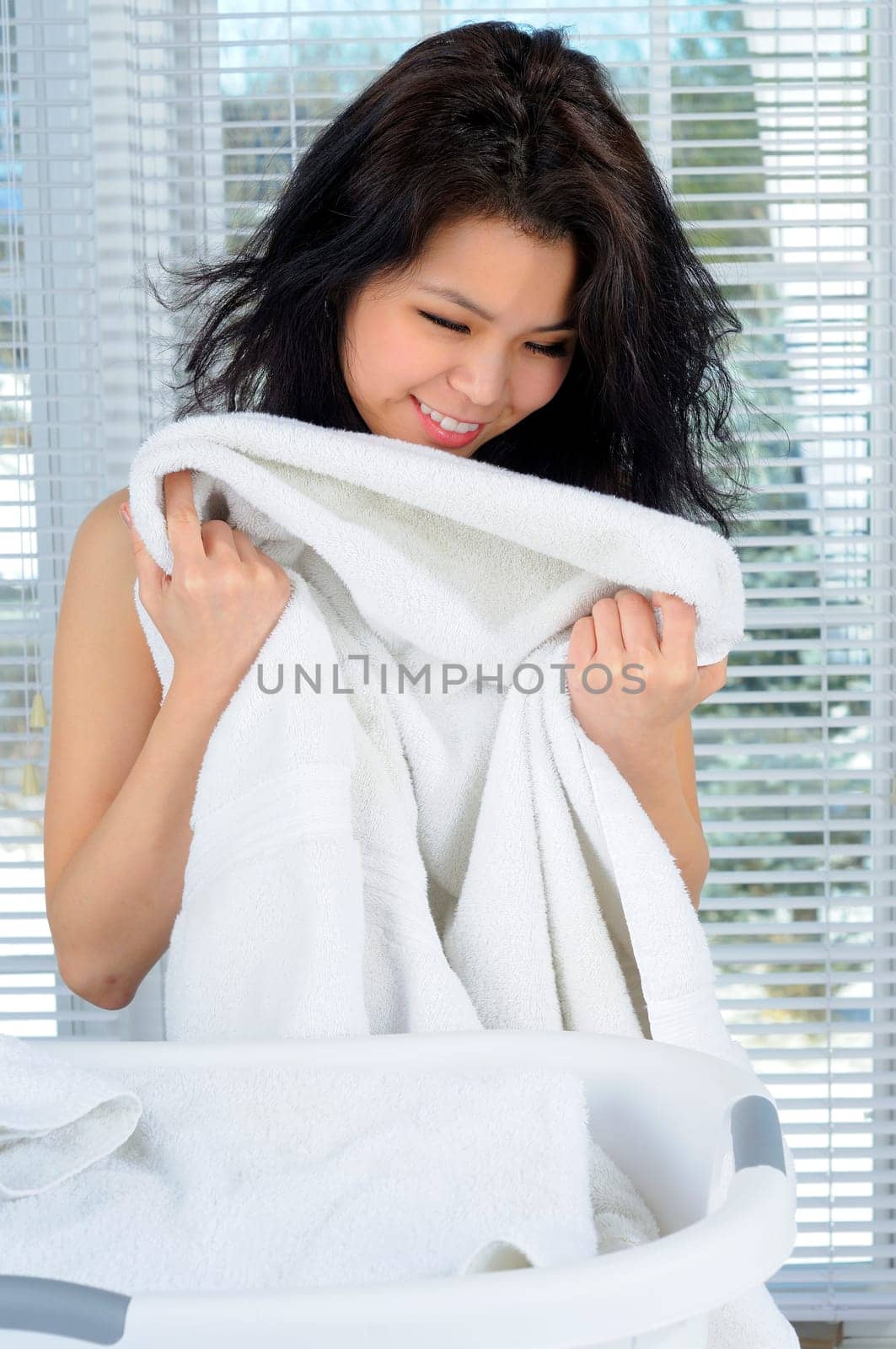 Pretty Chinese Girl With Long Hair Doing Laundry At Home