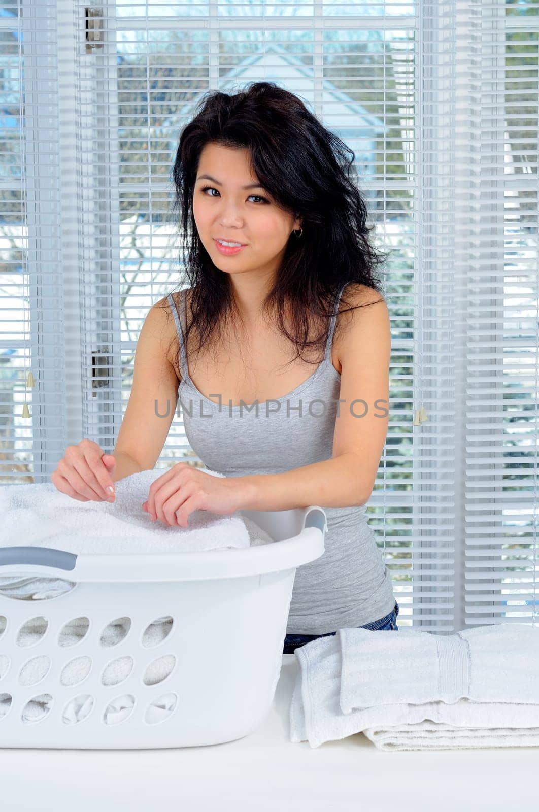 Pretty Chinese Girl With Long Hair Doing Laundry At Home