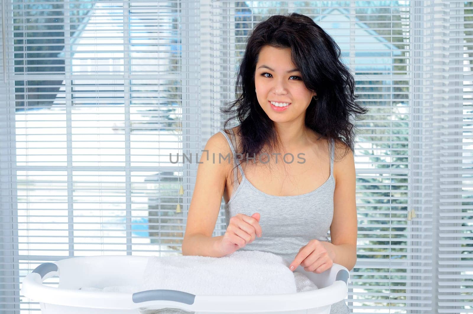 Pretty Chinese Girl With Long Hair Doing Laundry At Home