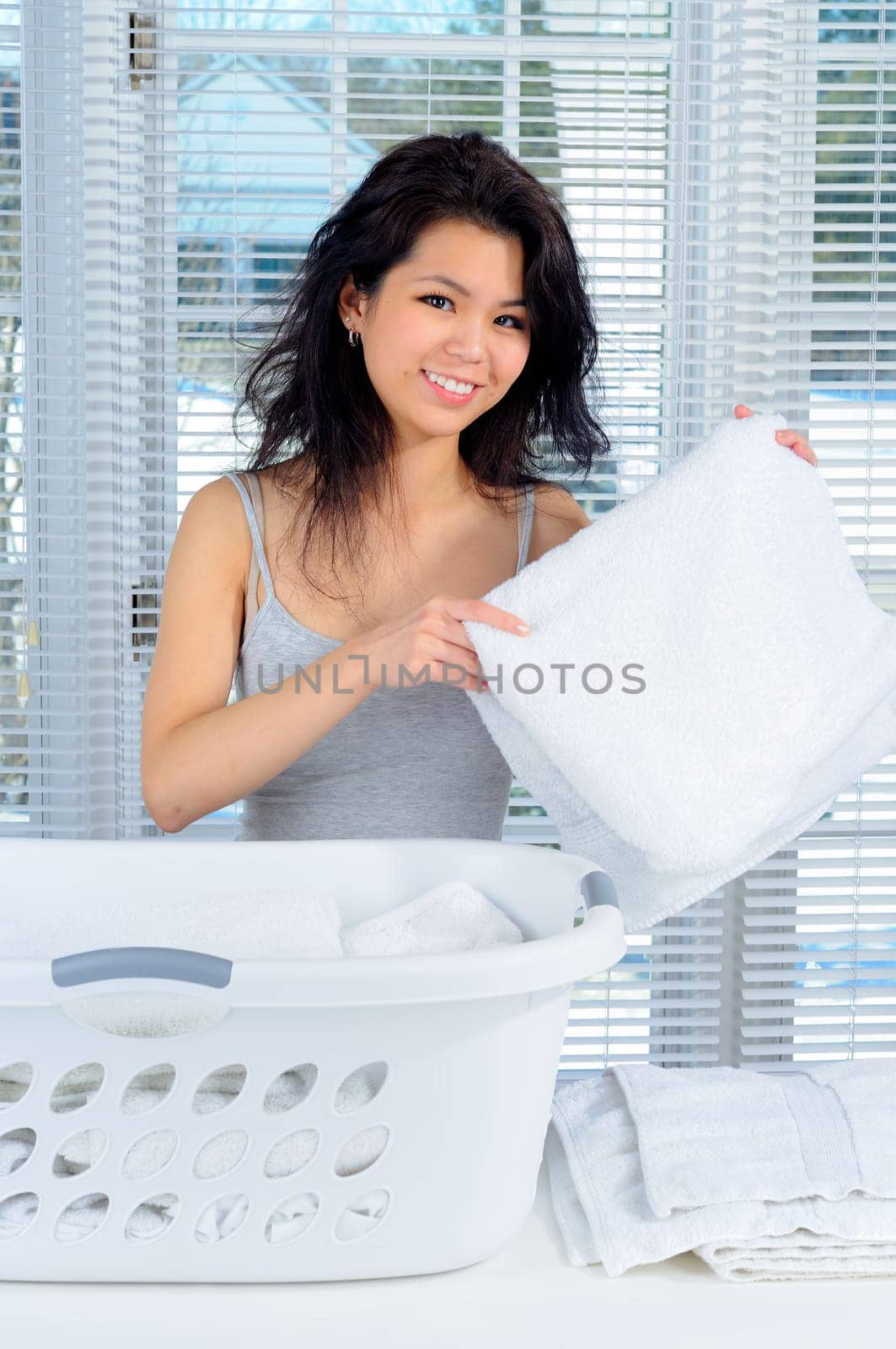 Pretty Chinese Girl With Long Hair Doing Laundry At Home