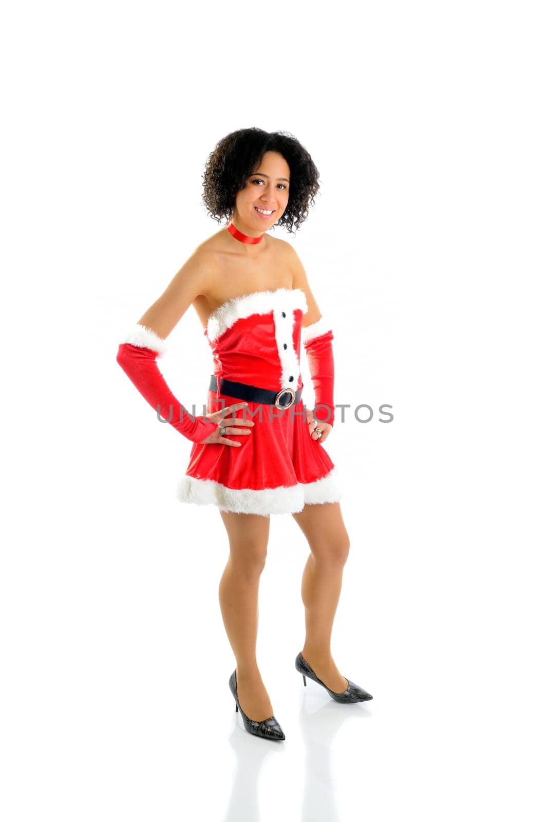 Beautiful African American Young Woman Standing Dressed In A Sexy Santa Costume Isolated On A White Background
