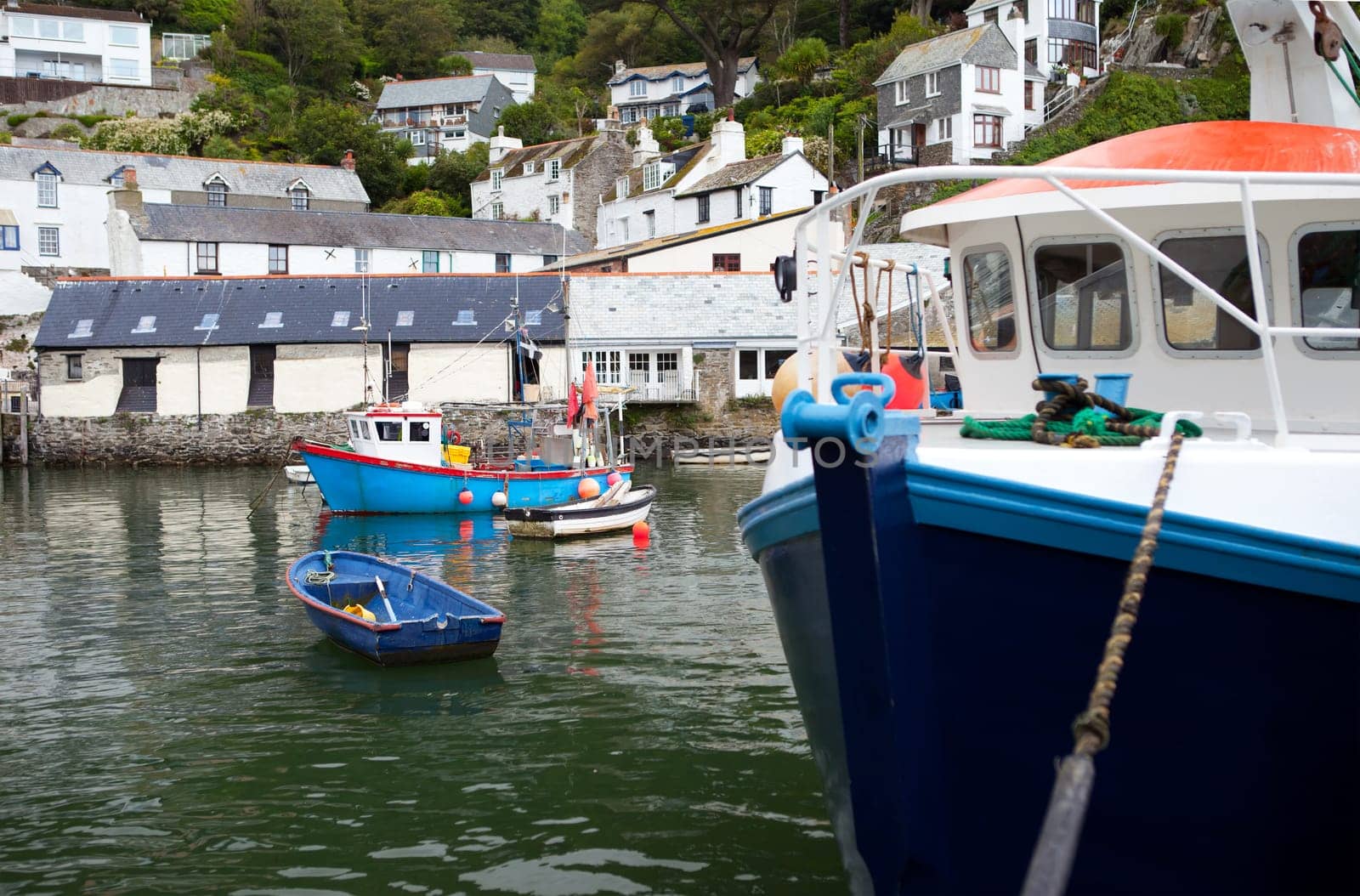 fishing boats in historic village Polperro in Cornwall. Cornish Harbor with boats and cottages