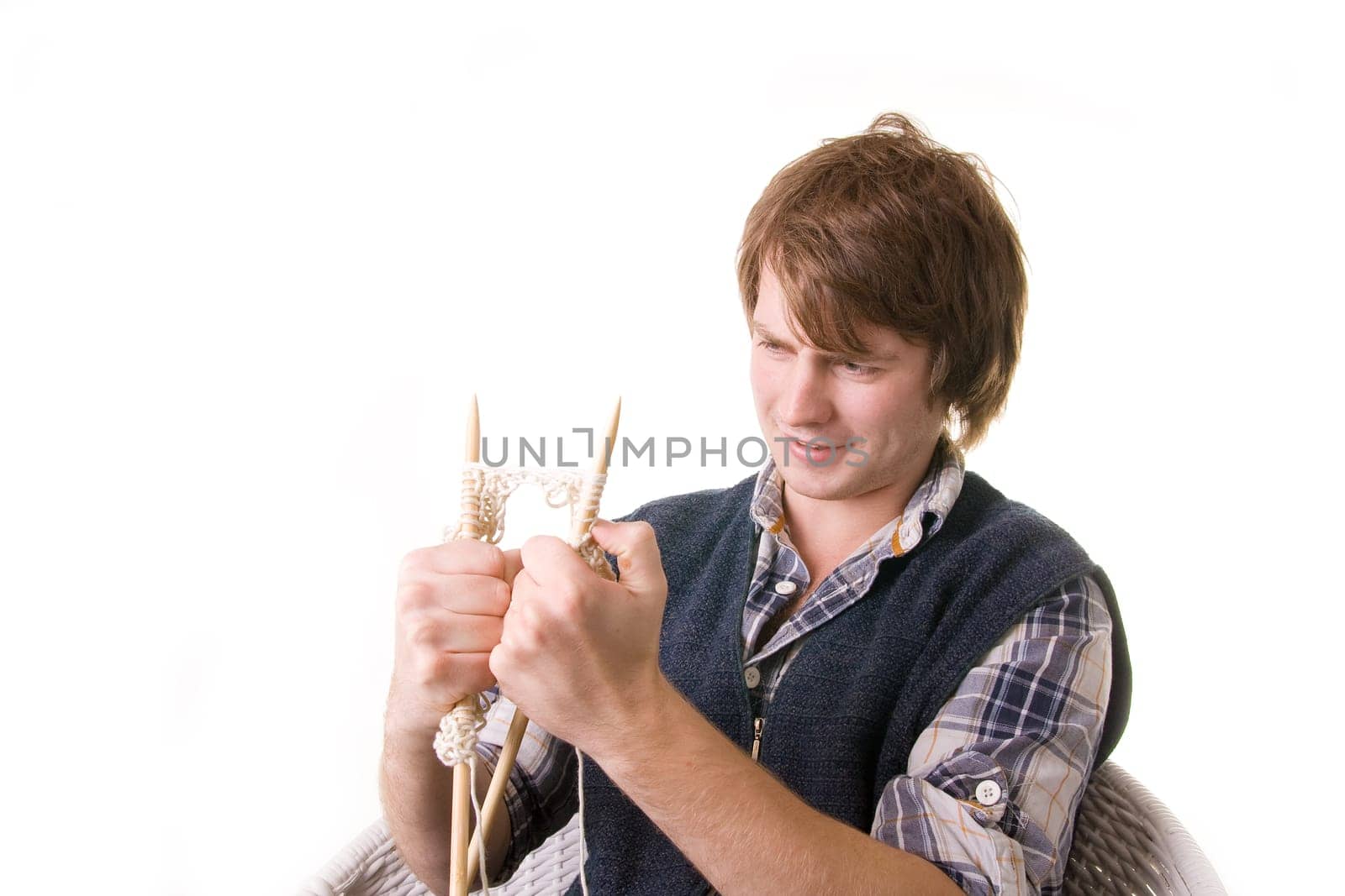 Man knitting, male working on craft knit with needles isolated on white