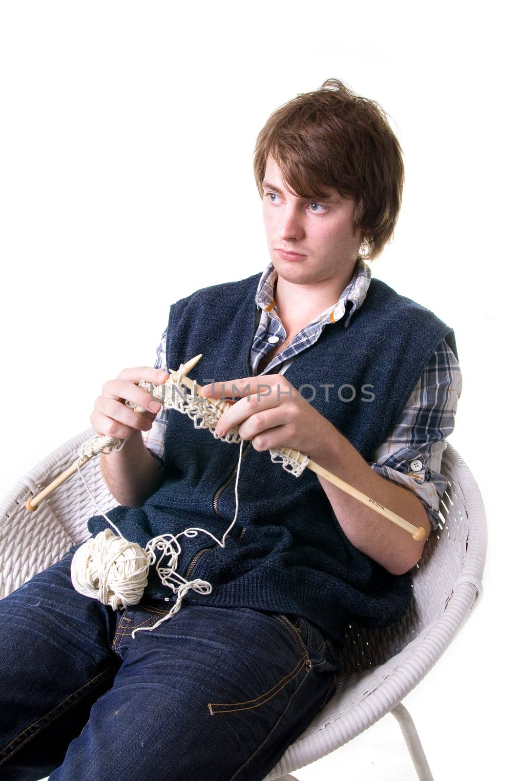 Man knitting, male working on craft knit with needles isolated on white