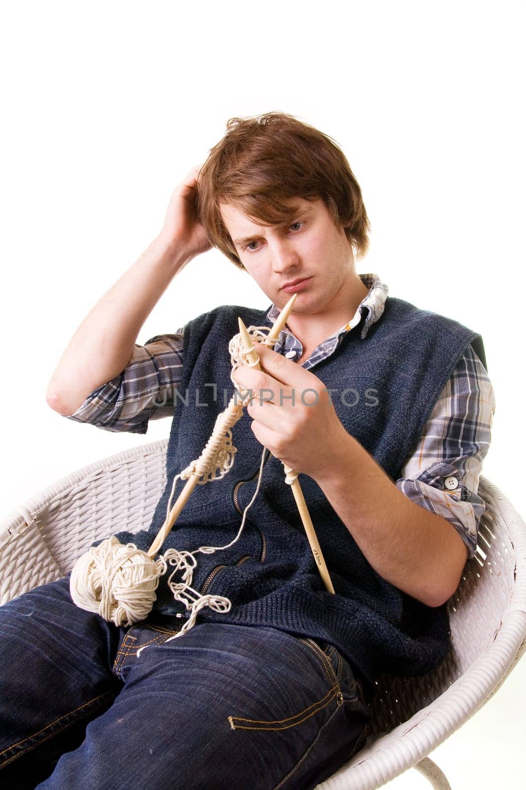 Man knitting, male working on craft knit with needles isolated on white