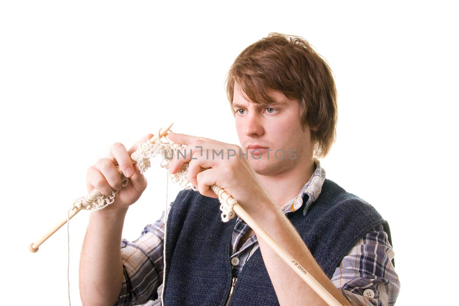 Man knitting, male working on craft knit with needles isolated on white