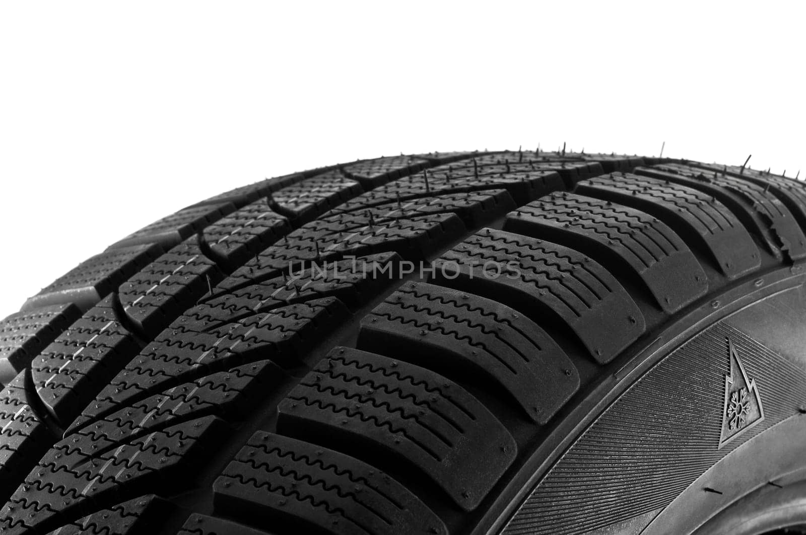 Winter tire close up on white background.