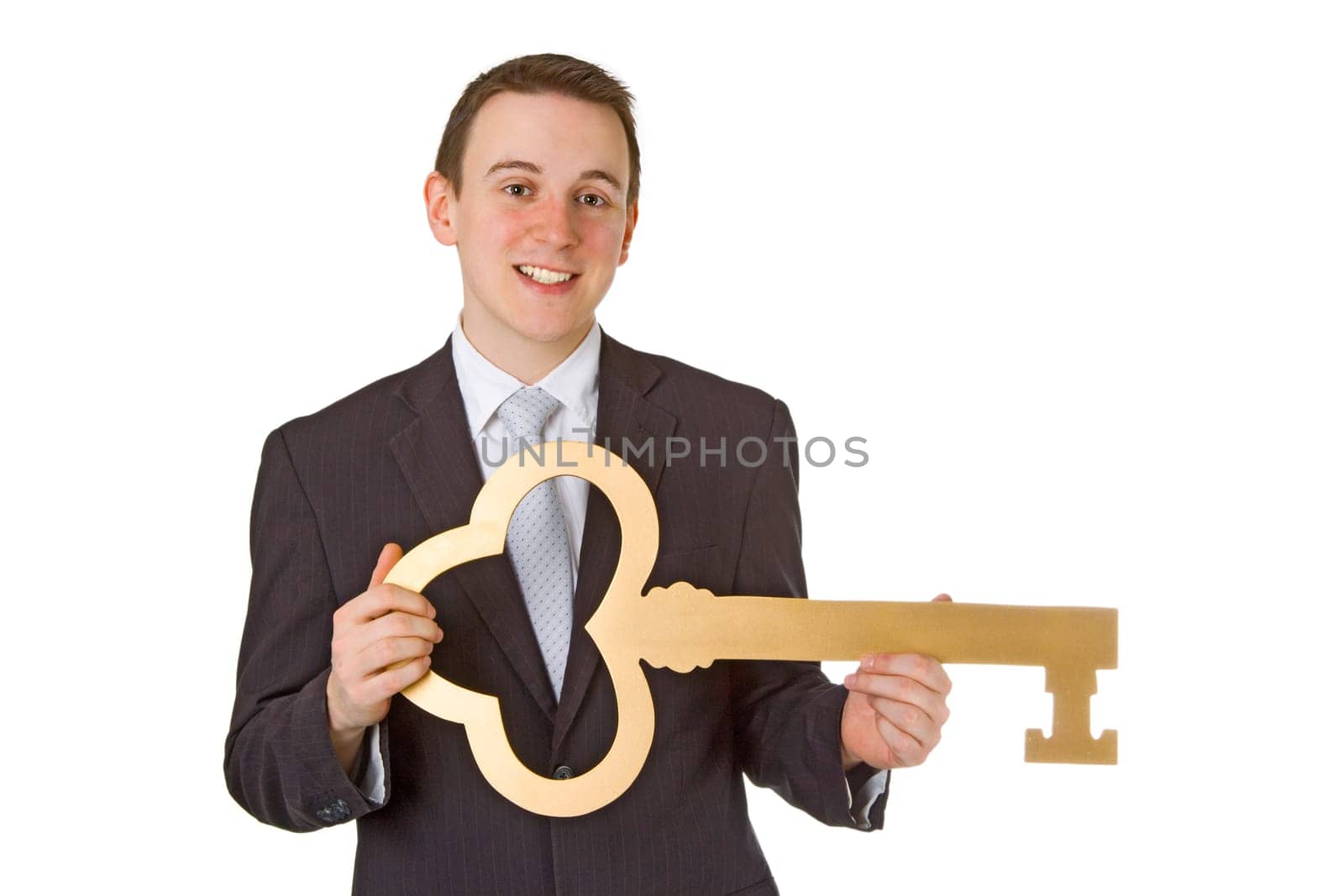 Businessman with a golden key isolated on white background