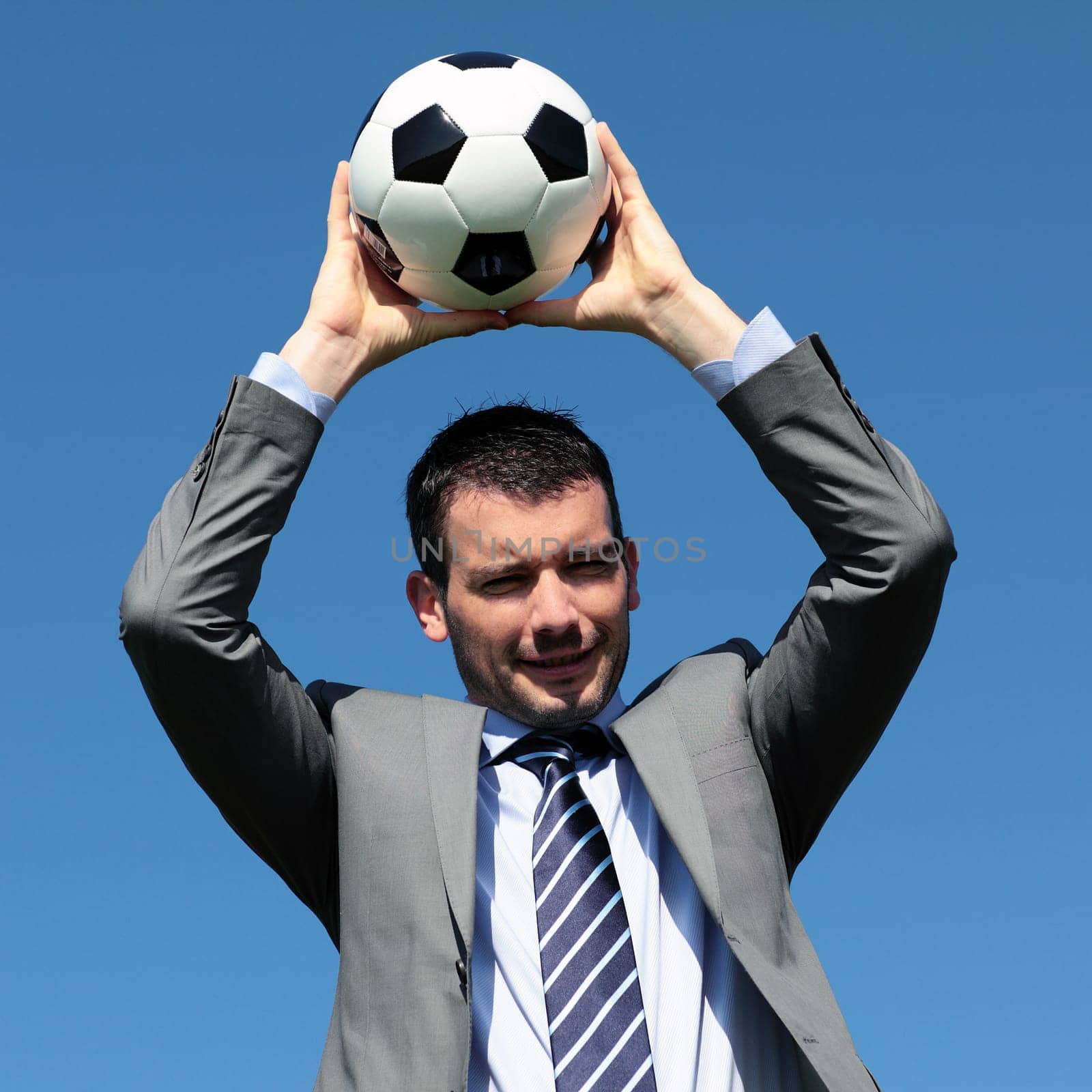 young coach with ball in blue sky
