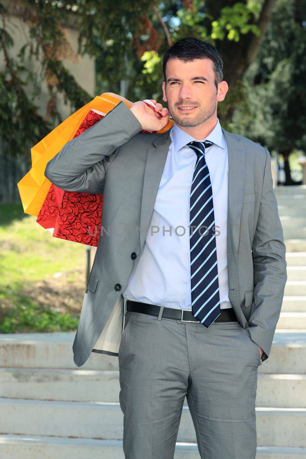 businessman with bags outdoor before christmas