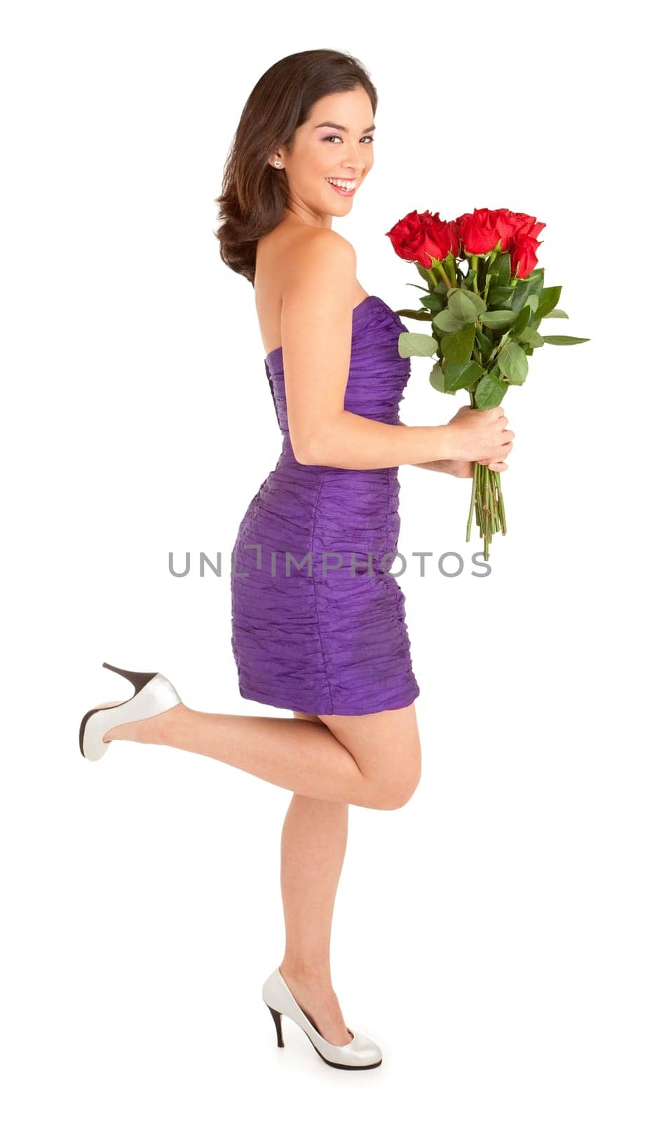 Woman in an evening dress is happily holding roses she just received