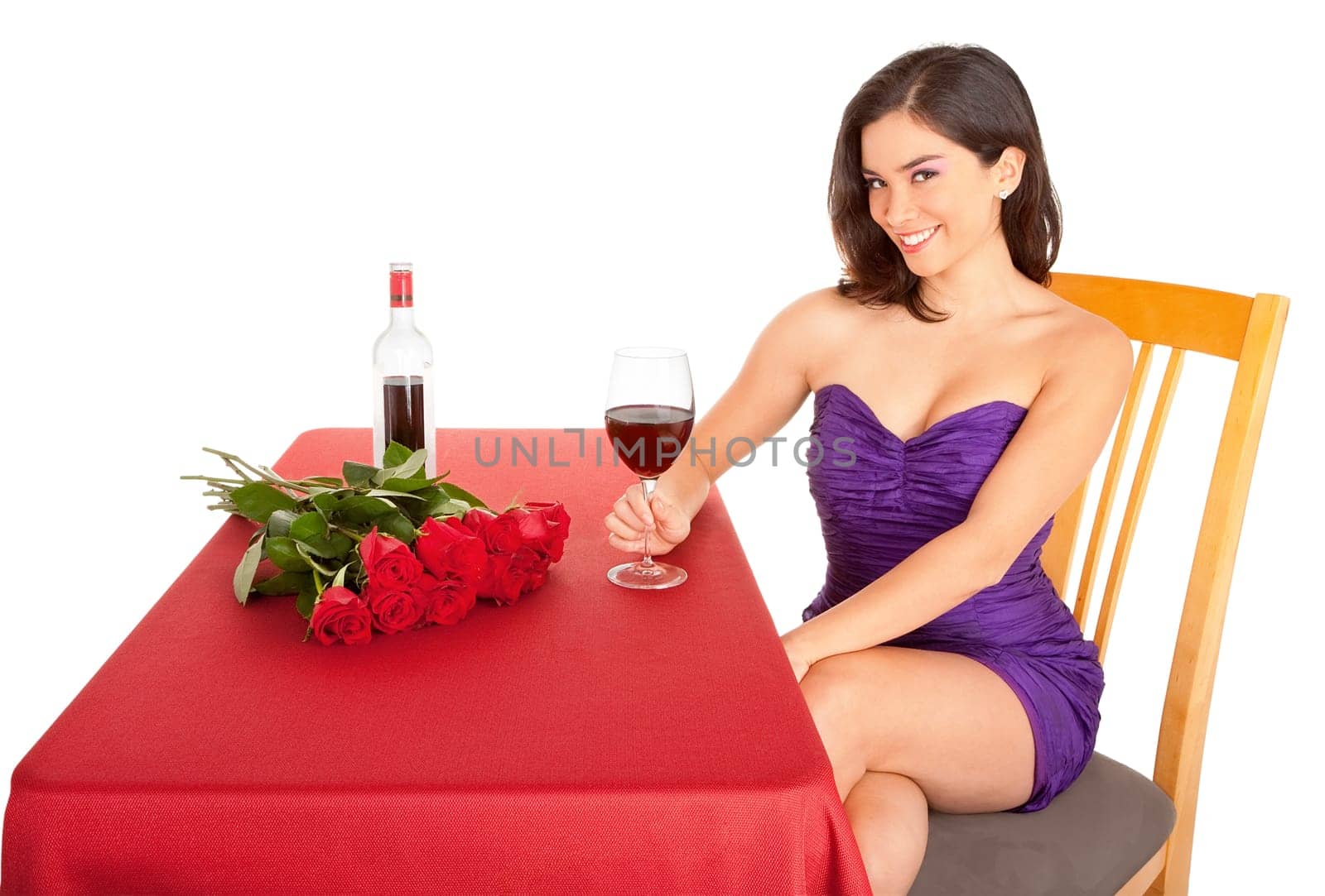 A woman is being courted by someone with flowers and red wine.