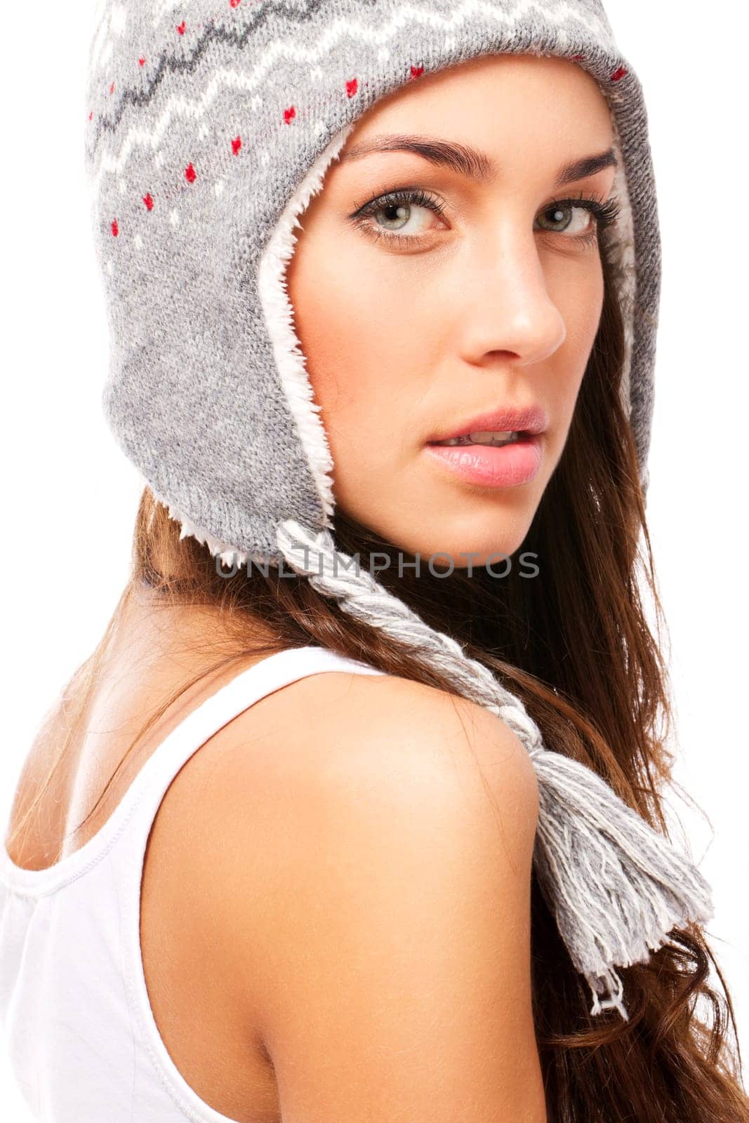 Beautiful woman in winter hat looking over her shoulder on white background