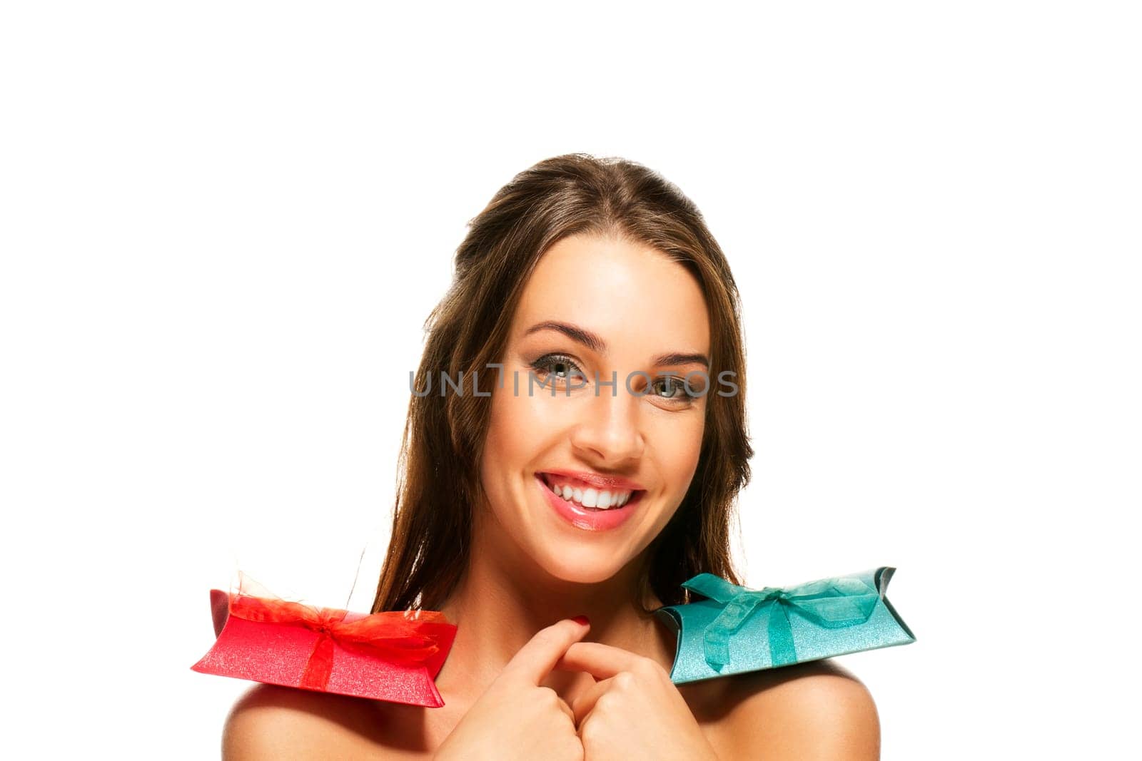 Beautiful woman with gifts on her shoulders on white background