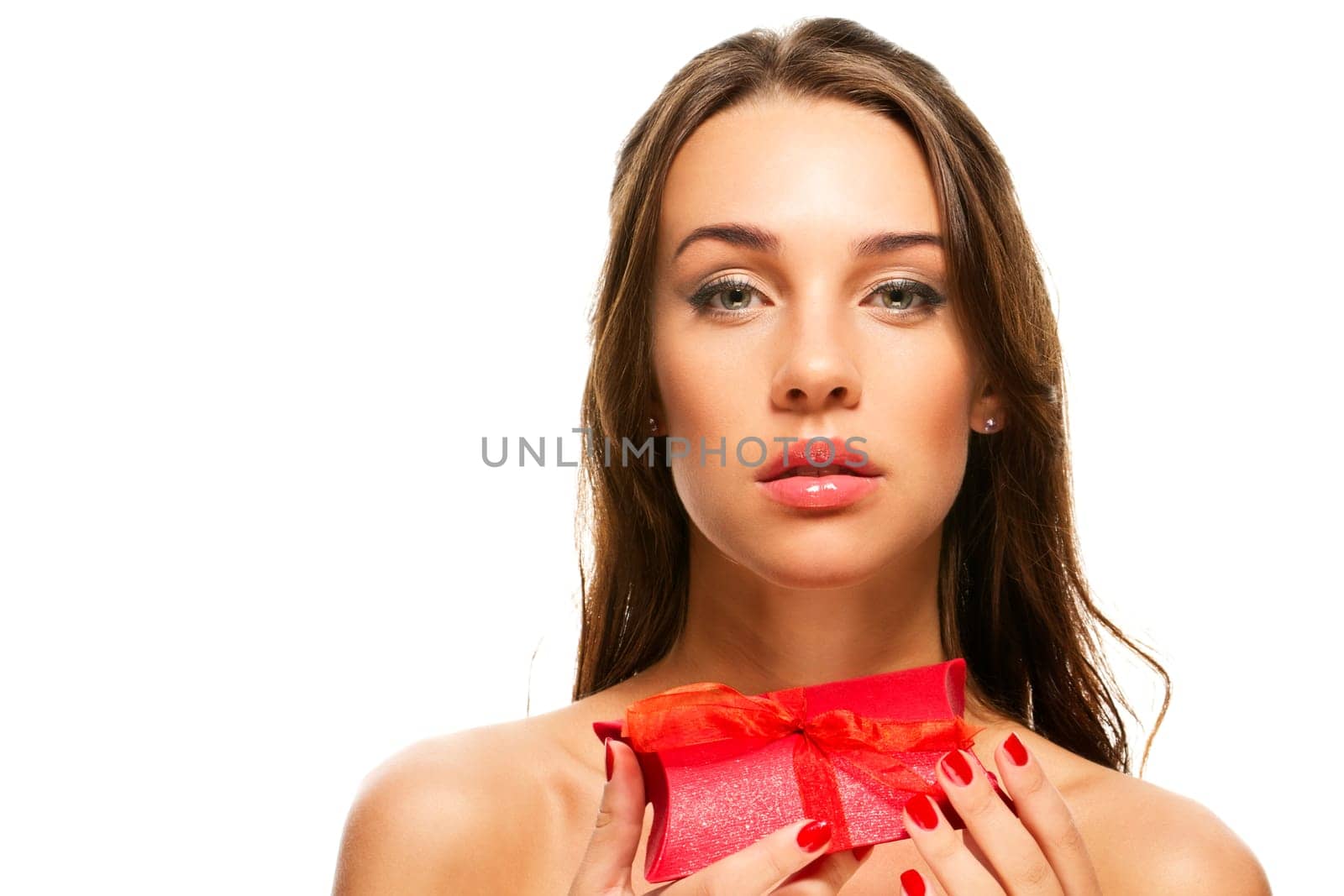 Beautiful woman holding red gift on white background