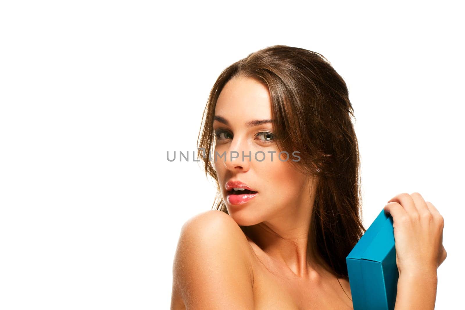 Beautiful woman holding gift very close on white background