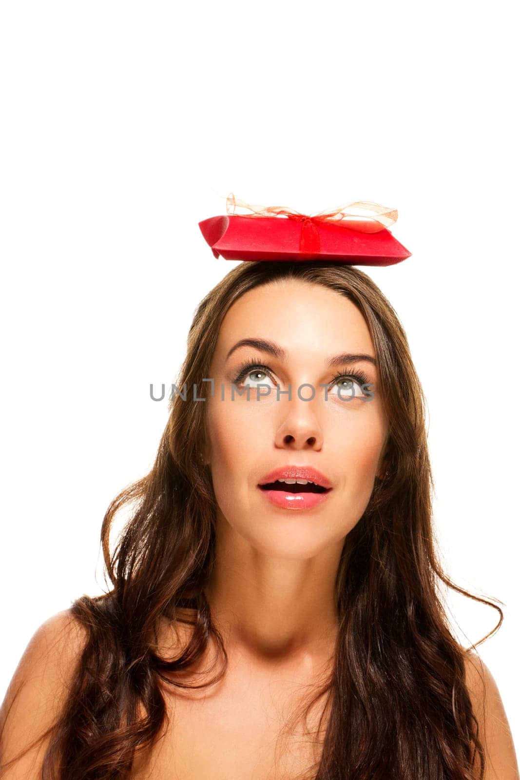 Beautiful woman with gift on her head on white background