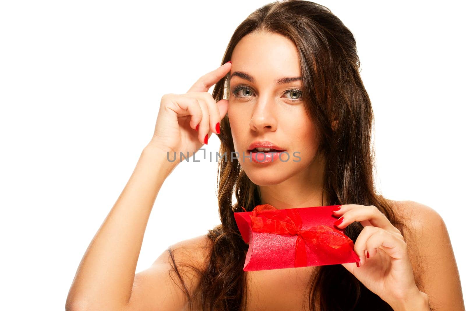 Young woman with red gift thinking on white background