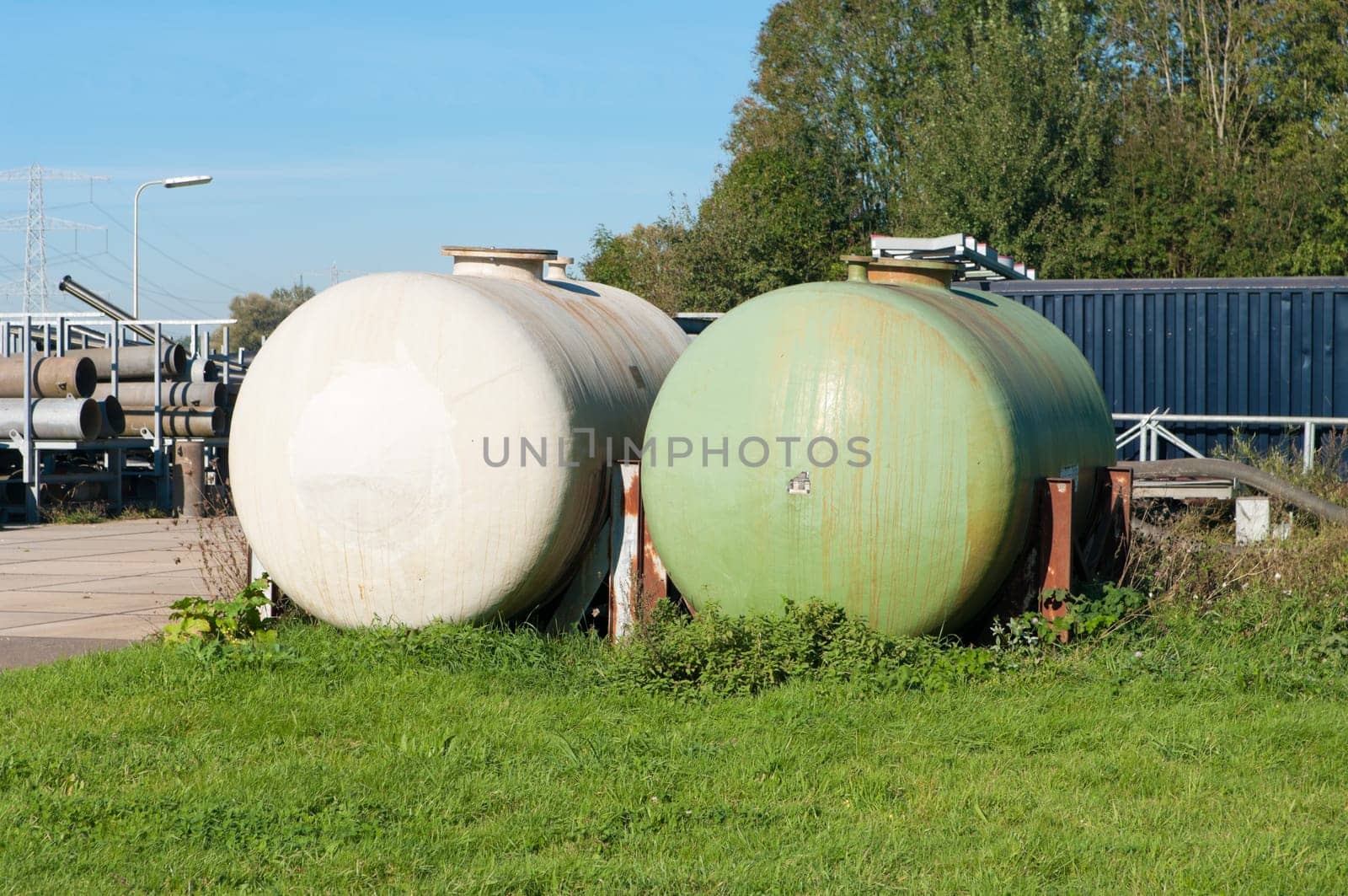 white and green storage tanks
