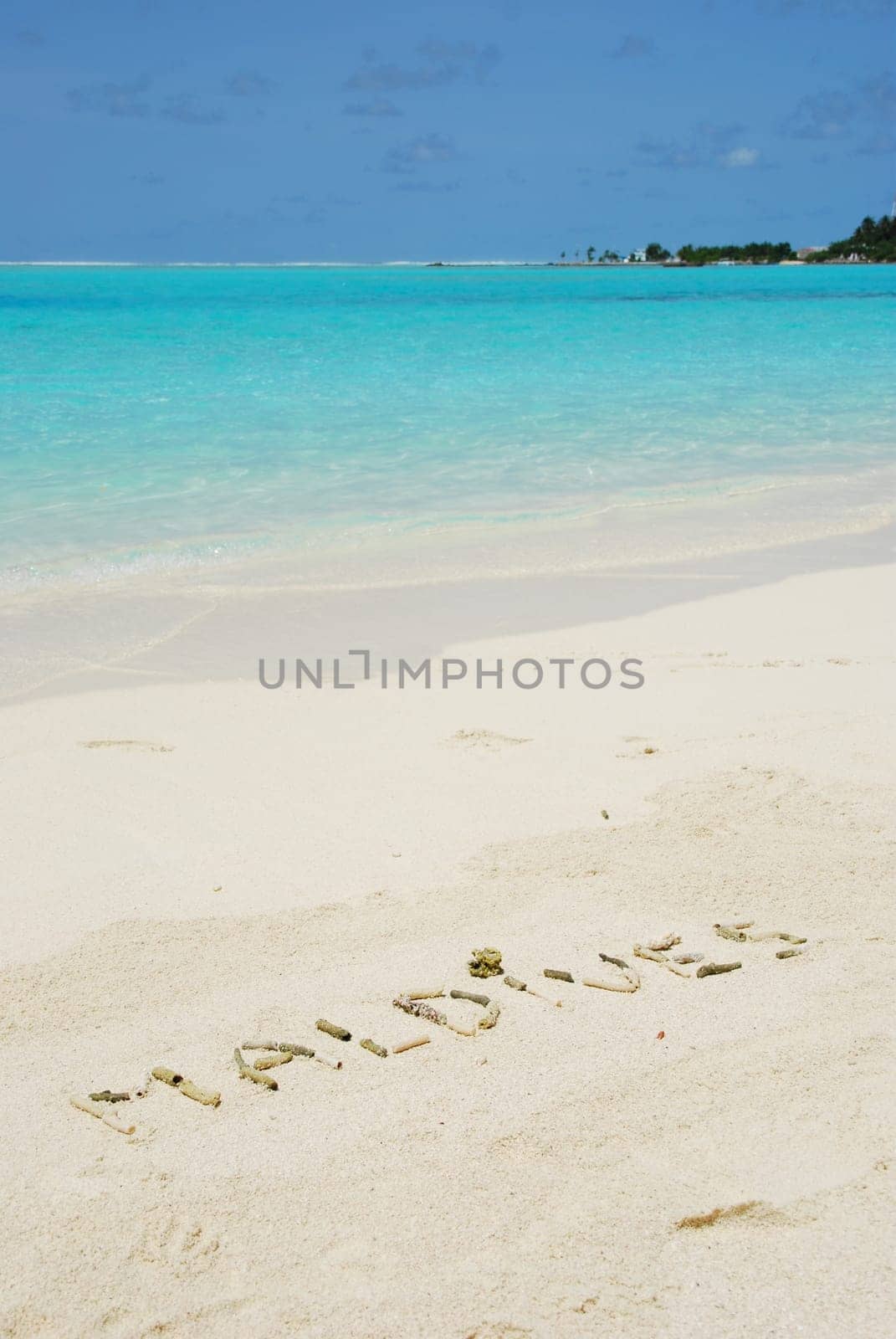 Maldives note written on a white sandy beach