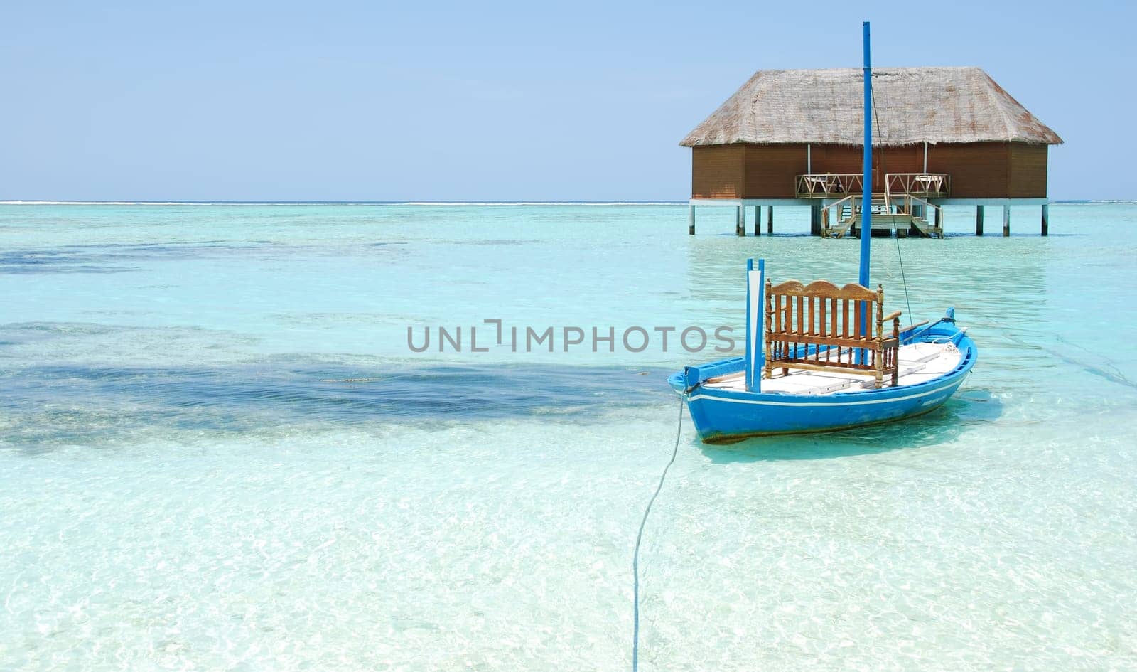 beautiful seascape with honeymoon villa in Maldivian Island and typical boat