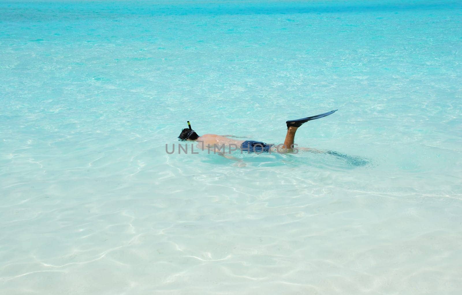 young man snorkeling in a tropical island