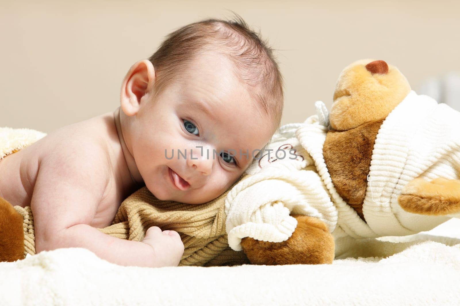 newborn lying on the cute toy bear