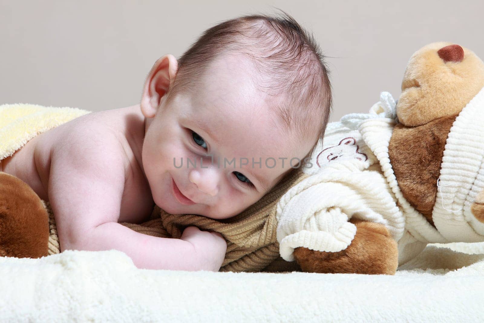 newborn lying on the cute toy bear
