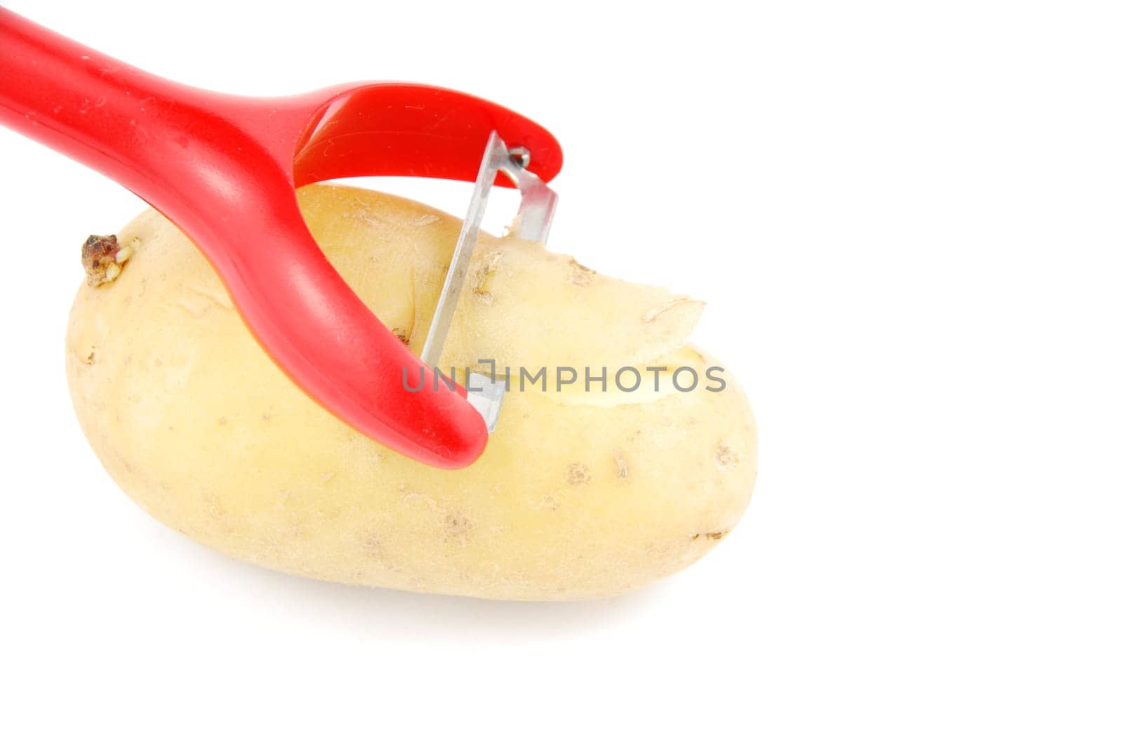 peeling a potato with peeler isolated on white background