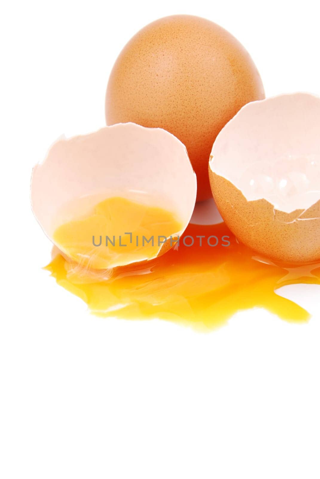 broken egg with the yolk and white oozing out isolated on white background