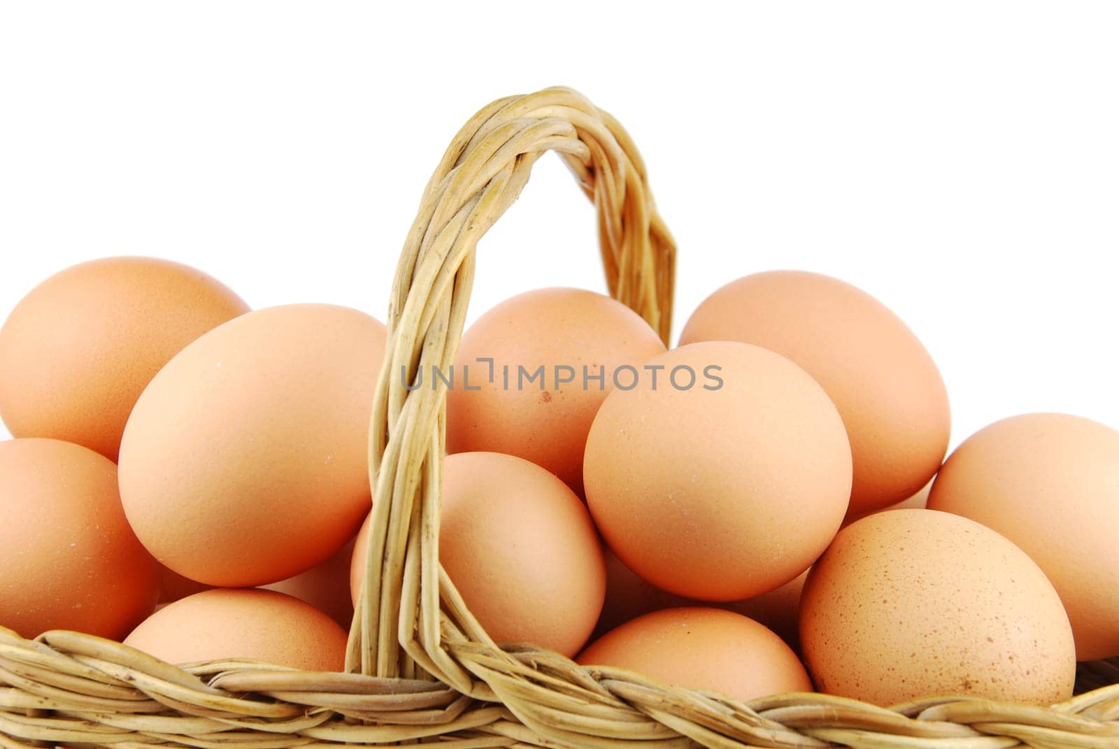 close-up of eggs in a traditional wicker basket isolated on white background