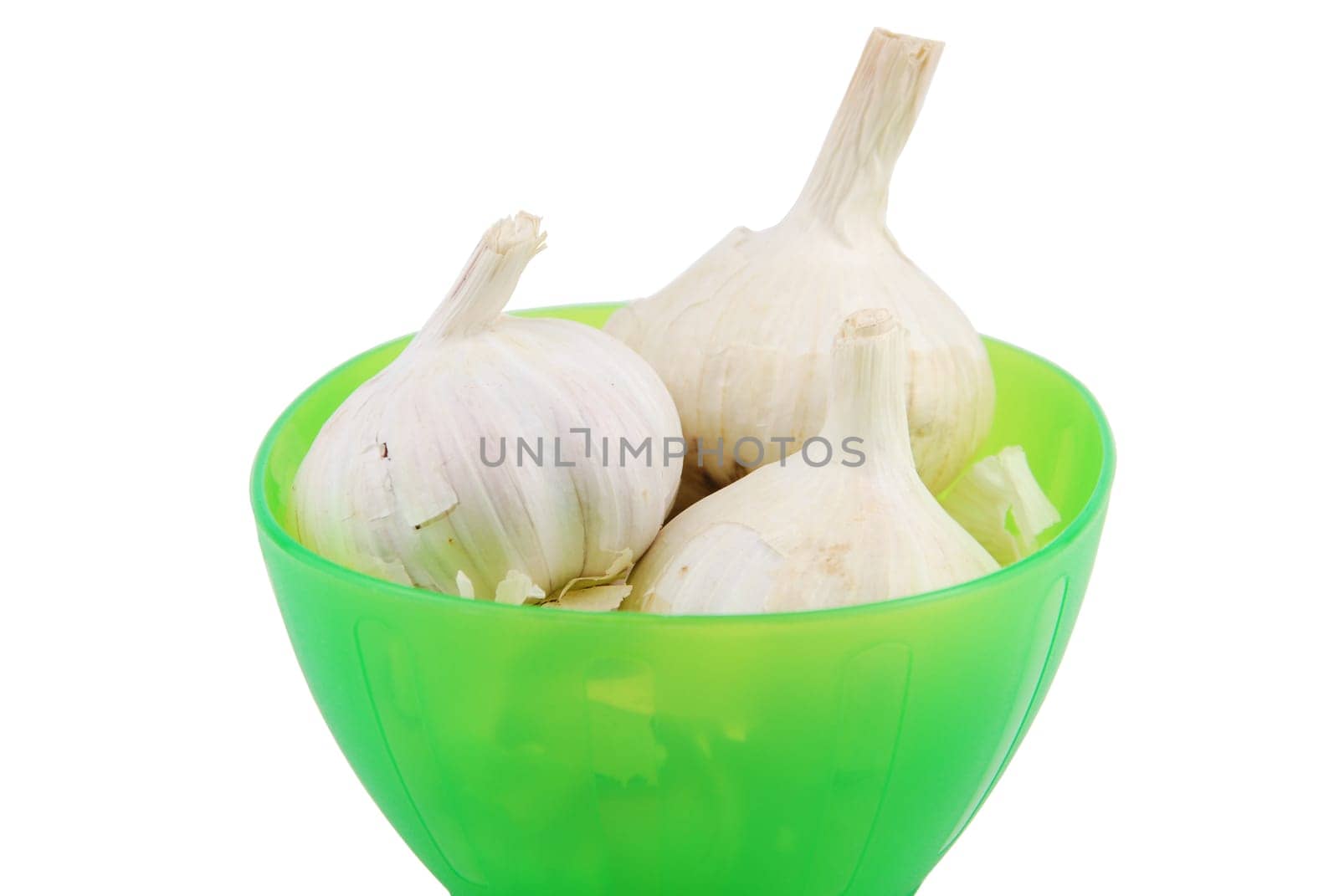 green bowl full of fresh garlic isolated on white background