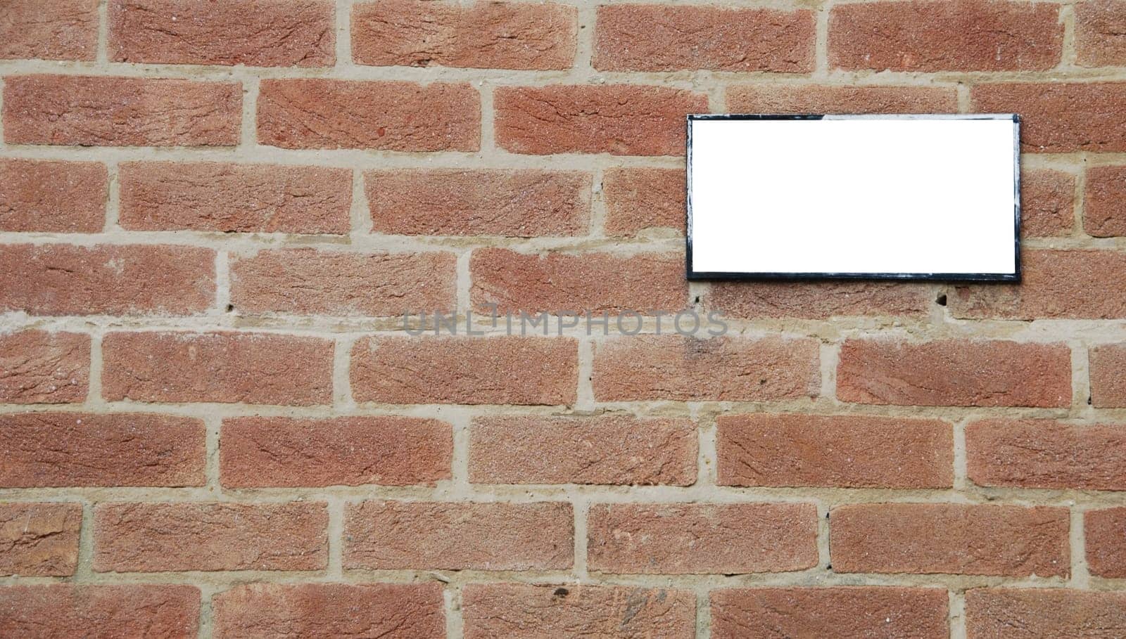 empty billboard on a beautiful brick wall building