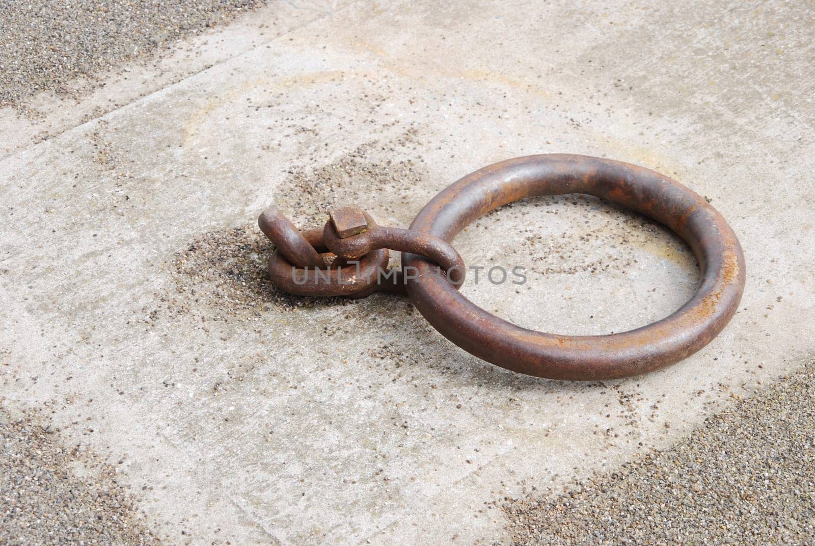 old and rusty mooring ring for ships on dock
