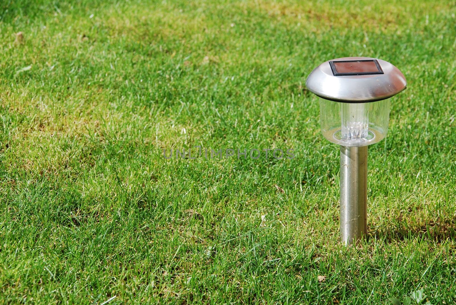 close-up of a solar garden light on green grass